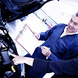 Mechanic Checking Details With Client